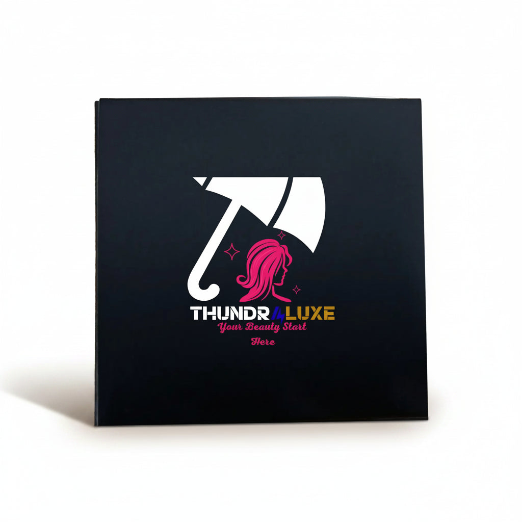 Black box with a logo featuring an umbrella and pink hair, labeled 'THUNDR4LUXE'.