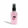 Pink spray bottle with a logo on a white background