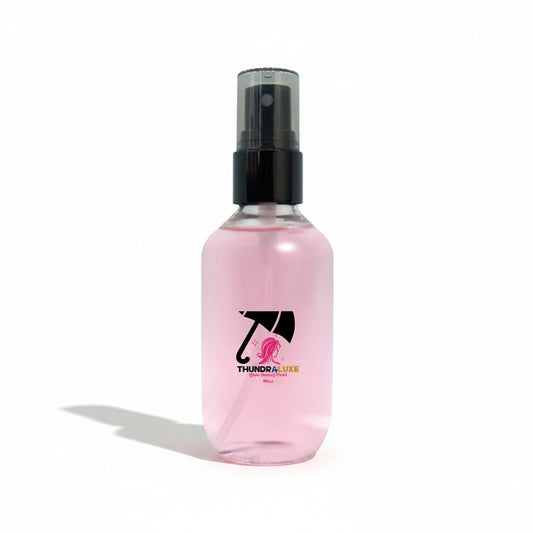 Pink spray bottle with a logo on a white background