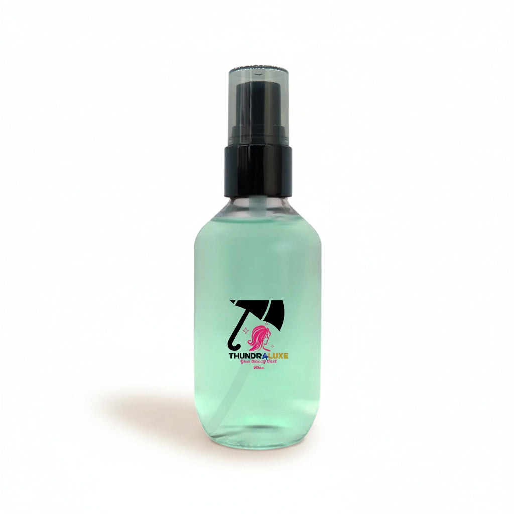 Clear spray bottle with black nozzle on a white background