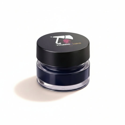 Blue eye makeup product with 'Thunder Luxe' branding on a glittery background