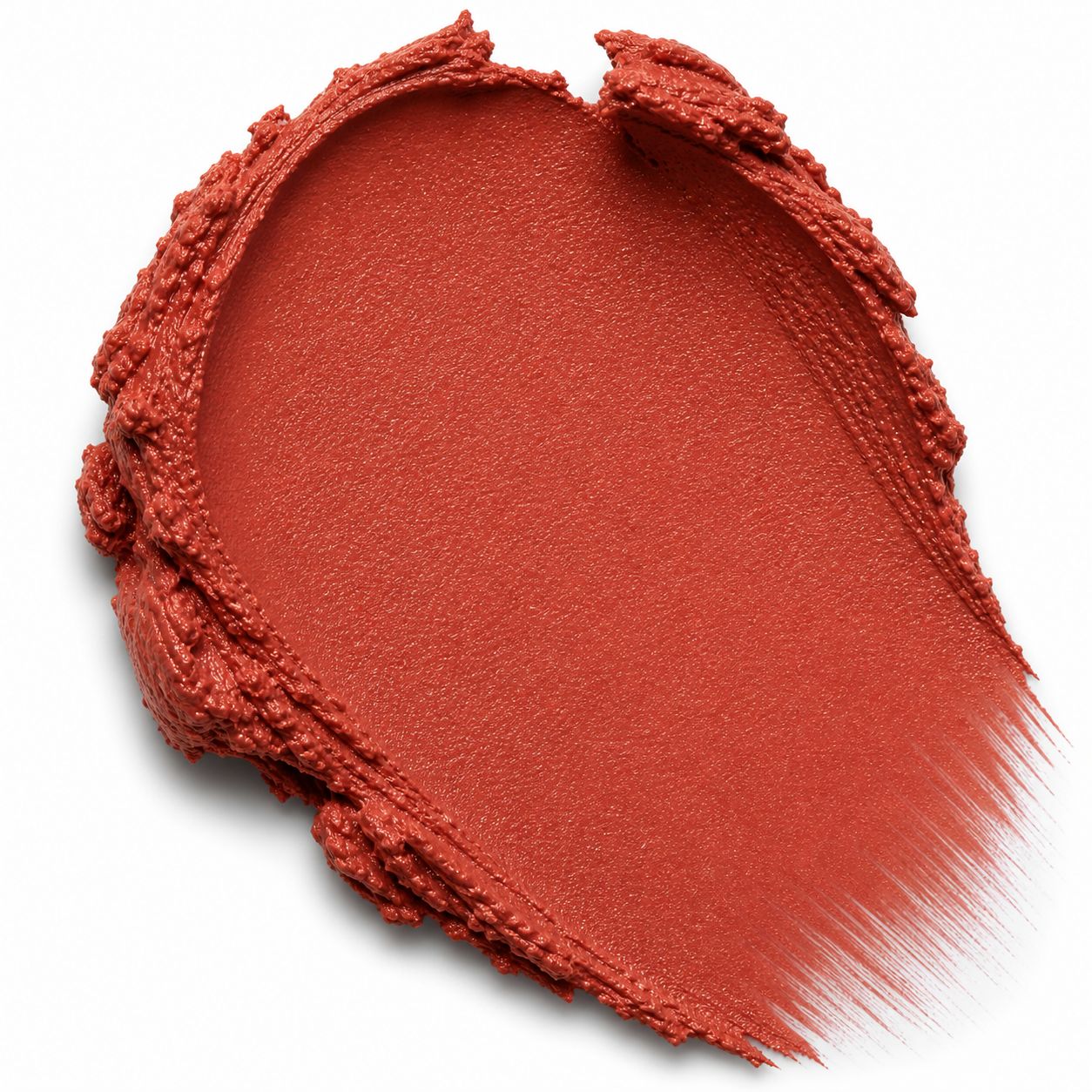 Close-up of a red makeup swatch with a brush on a white background